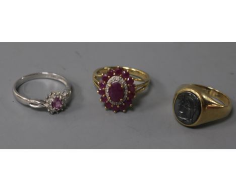 A 9ct white gold, pink sapphire and diamond cluster ring, another cluster ring and a 9ct yellow gold signet ring