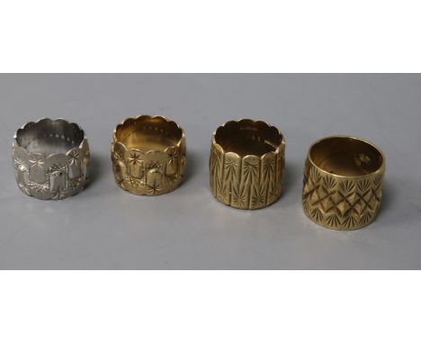 Four 9ct white and yellow gold textured scarf rings.