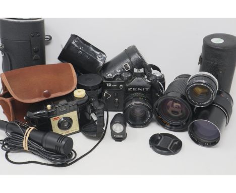 Zenit 12xp camera with lenses including a Helios 44 mm/4, Fujinon and Optimax. UK P&amp;P Group 3 (£30+VAT for the first lot 