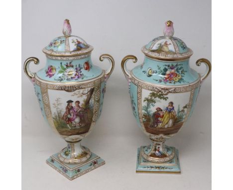 Pair of Dresden covered twin handled urns decorated with courting couples and flowers, base loose to both, one with extensive