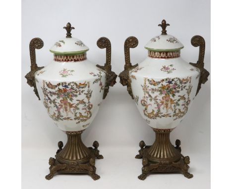 Pair of large Victorian style covered urns on brass supports, H: 45 cm, one finial re-glued and heavy crazing throughout. Not