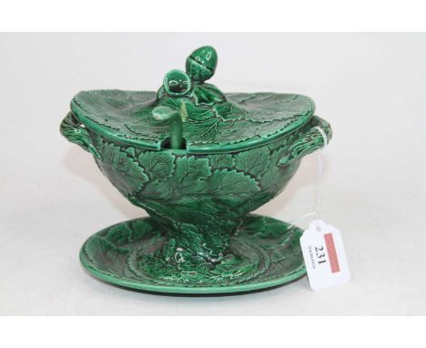 A green glazed tureen, relief decorated with foliage and having an acorn finial, h.16cmLadle is restored.Restored to the rim.