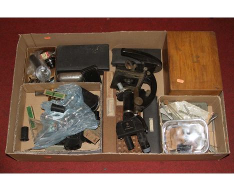 A collection of microscope equipment to include a mid 20th century Carl Zeiss binocular microscope, various microscope parts,