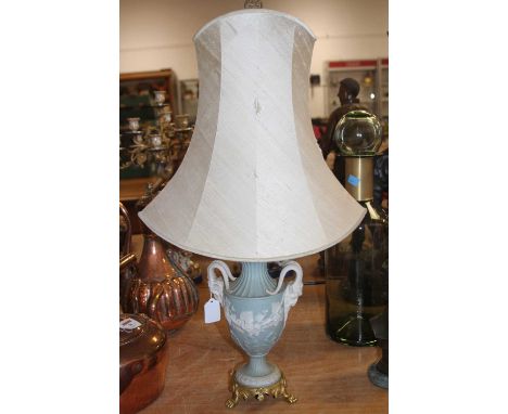 A green jasperware table lamp, of baluster form, flanked by goat masks, h.74cm (including shade)