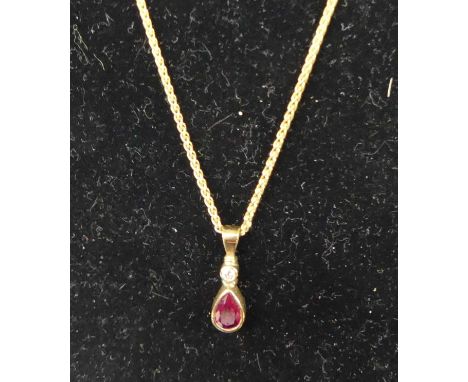 A modern 9ct gold ruby and diamond set pendant on fine link neck chain, gross weight 2.9gChain length 41cm.