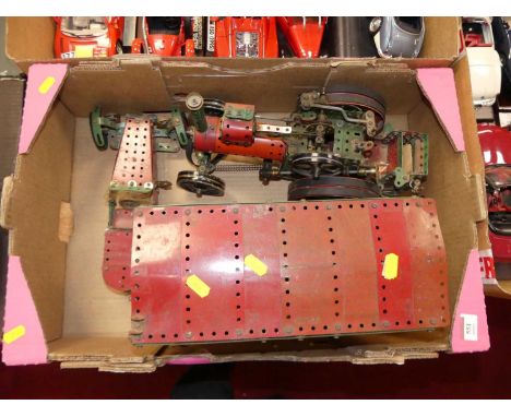 A 1960s Meccano red and green construction model of a traction engine, with travelling caravan and three-wheel racing car 