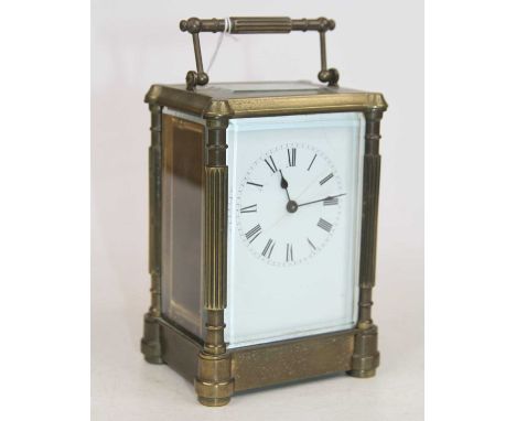 A brass carriage clock, the enamel dial showing Roman numerals, having visible platform escapement, h.14cm 