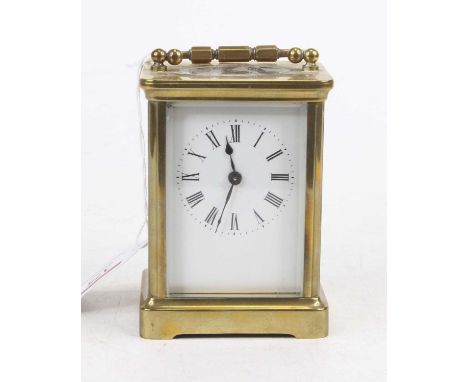 A mid-20th century lacquered brass cased carriage clock, having an enamelled dial with Roman numerals, visible platform lever