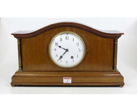 An Edwardian walnut cased mantel clock, the enamel dial with Arabic numerals and twin winding holes for an 8-day movement, st
