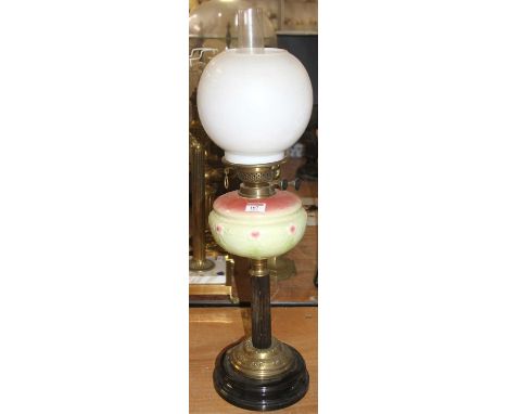 A 19th century brass oil lamp, having a milk glass shade and pottery font, h.67cmCouple small chips to rim of shade, chips to