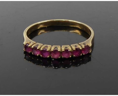 A modern 9ct gold and ruby set half eternity ring, 1.6g, size M 