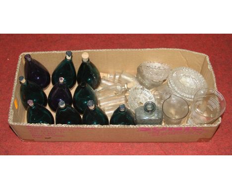 A collection of glassware to include a set of ten green glass bottles and stoppers, and various Clarks moulded glass fairy li