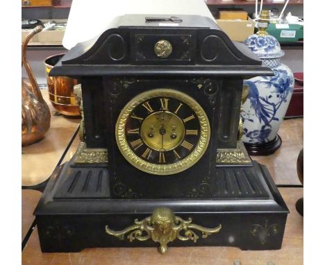 A Victorian black slate eight-day mantel clock, of architectural form, the chapter ring showing Roman numerals, having visibl