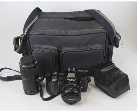 A Minolta 35mm SLR camera, with bag, and accessoriesNot currently working and may require a new battery.