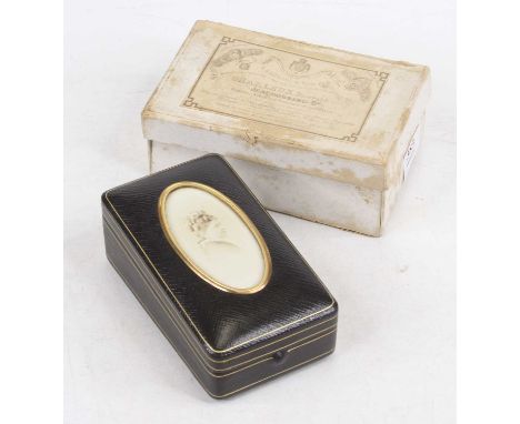 A late 19th century French leather clad memorial box, of hinged rectangular form, the cover with oval photographic portrait p