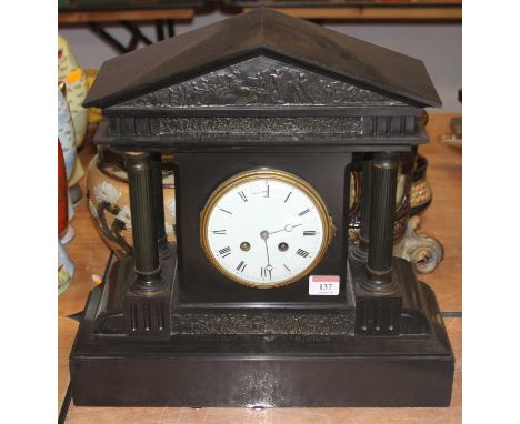A Victorian black slate eight-day mantel clock, of architectural form, having an enamelled dial showing Roman numerals, h.39c