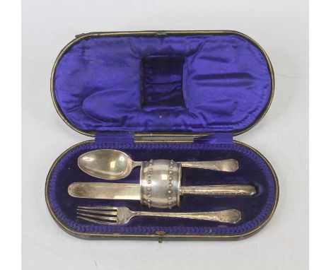 An Edwardian silver four piece christening set in fitted case, comprising knife, fork, spoon, and napkin ring, Sheffield 1906