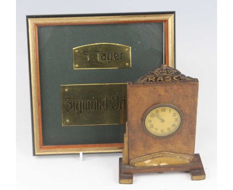 A WW II period mantel clock, the circular dial with Arabic numerals signed Asprey, housed in a leather clad surround surmount