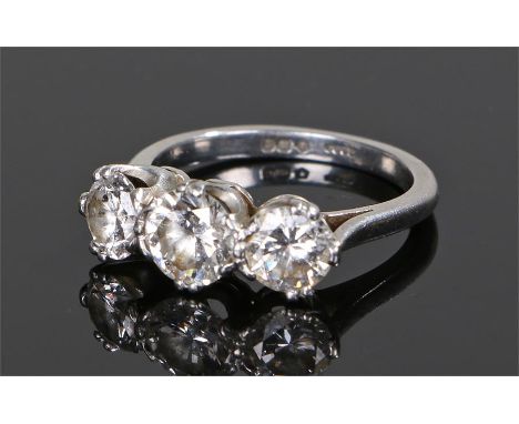 Platinum and diamond ring, with three round cut diamonds to the head, the central diamond at approximately 0.9 carat flanked 