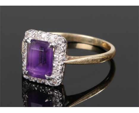 18 carat gold amethyst and diamond set ring, the emerald cut amethyst with a diamond surround, ring size Q 1/2