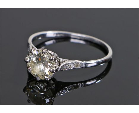 Platinum diamond set solitaire ring, the central diamond at approximately 1.65 carat flanked by two round cut diamonds to eit