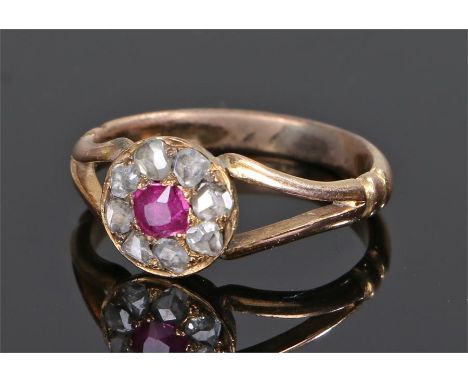 Ruby and diamond ring, the central ruby with a rose cut diamond surround, ring size K