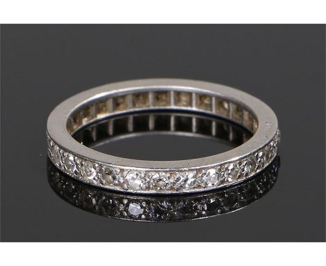 Platinum and diamond set eternity ring, set with round cut diamonds to the ring surround, ring size L