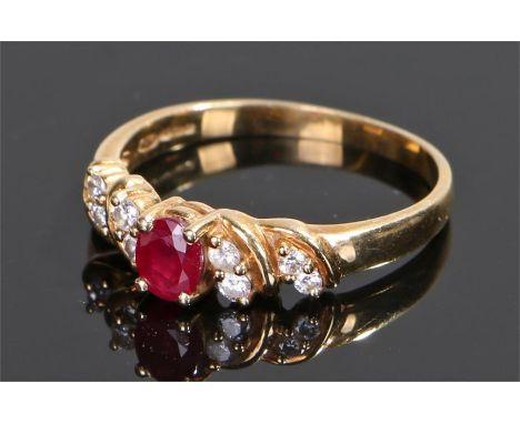 18 carat gold ruby and diamond ring, the central ruby flanked by a total of eight round cut diamonds, ring size P