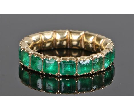 18 carat gold emerald eternity ring, the ring set with seventeen emerald cut emeralds, ring size L