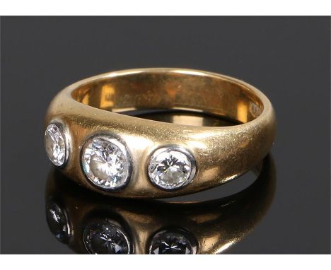 18 carat gold diamond set gentleman's ring, the central diamond at approximately 0.5 carat flanked by a further two round cut