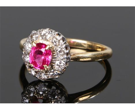 18 carat gold ruby and diamond set ring, the central ruby with a diamond surround, ring size M