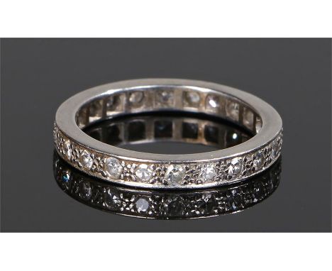 Diamond set eternity ring, in white metal with round cut diamonds surround, ring size M