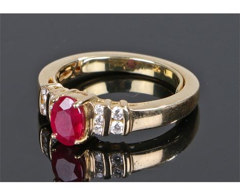 18 carat gold ruby and diamond ring, the central oval ruby with ten small diamonds to the shoulders, ring size M