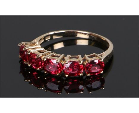 9 carat gold Tanzanian ruby ring, with a row of five Tanzanian rubies, ring size O