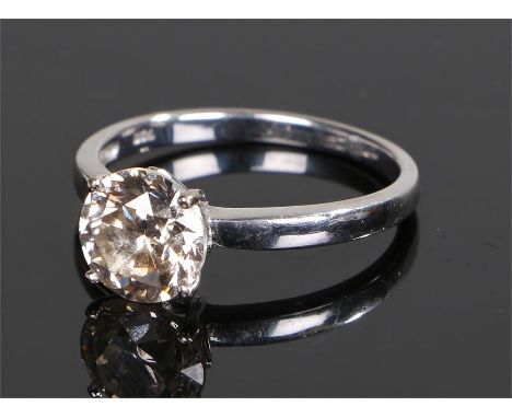 18 carat white gold champagne diamond set solitaire ring, the round cut diamond at approximately 1.8 carats with a four claw 