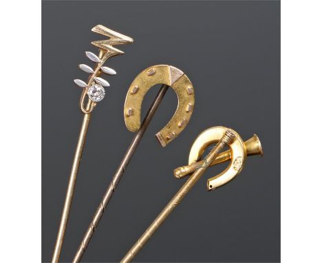 Stick pins, to include a diamond set example, a 15 carat gold horse shoe example and a 9 carat gold horse shoe with horn exam