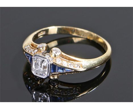 18 carat gold diamond and sapphire ring, by T O'Donoghue, the central diamonds at 0.75 carat, with twenty round cut diamonds 