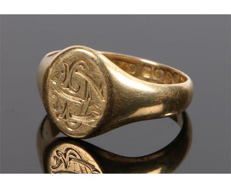 18 carat gold signet ring, with an oval head and engraved monogram, 7.5 grams, ring size V