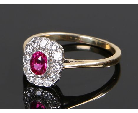 Ruby and diamond set ring, the central 0.51 carat ruby with a diamond surround, ring size O