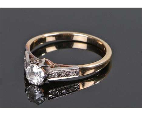 18 carat gold diamond solitaire ring, the round cut diamond at 0.38 carat with three diamonds to either side, ring size M