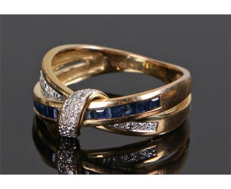 9 carat gold diamond and sapphire ring, with a cross over design set with twelve sapphires and ten round cut diamonds, ring s