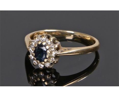 18 carat gold sapphire and diamond ring, the central oval sapphire with diamond surround, ring size L