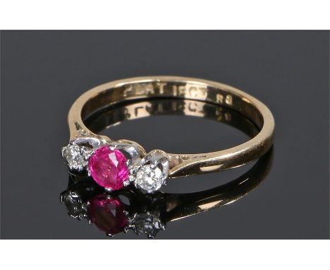 18 carat gold ruby and diamond ring, the central ruby flanked by a diamond to either shoulder, ring size N