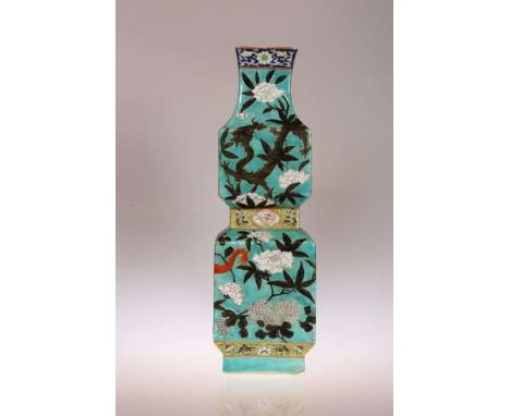 A CHINESE VASE
Of waisted square section, enamel painted with two four-clawed dragons against a turquoise ground.
36cm