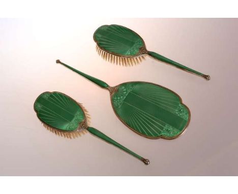 AN ART DECO SILVER AND GREEN ENAMEL DRESSING TABLE SET
Birmingham 1931
Comprising a pair of brushes and mirror, each with eng