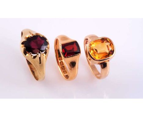 A GARNET AND GOLD SIGNET RING
c.1900
The oval cut garnet ten claw set in an open mount between tapering shoulders on a plain 