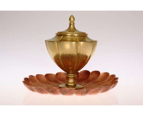 W.A.S. BENSON
AN ARTS AND CRAFTS COPPER AND BRASS INKWELL
The brass urn-form ink standing on a copper flowerhead base, stampe