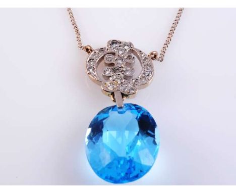 A BLUE TOPAZ AND DIAMOND PENDANT
The oval cut topaz suspending on an articulated link from a circular unusual shaped mount se