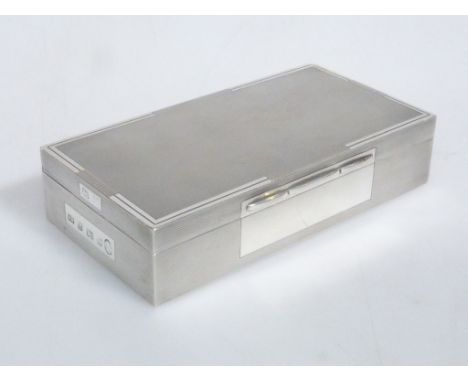 A SILVER CIGARETTE BOX A. Wilcox, Birmingham 1952 In Art Deco style with engine-turning, weighted. 17cm by 9cm