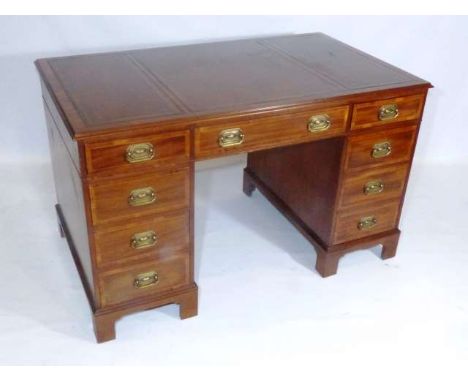 A GEORGIAN STYLE MAHOGANY DESK
The rectangular top with three-piece gilt-tooled leather, over three frieze drawers over two p